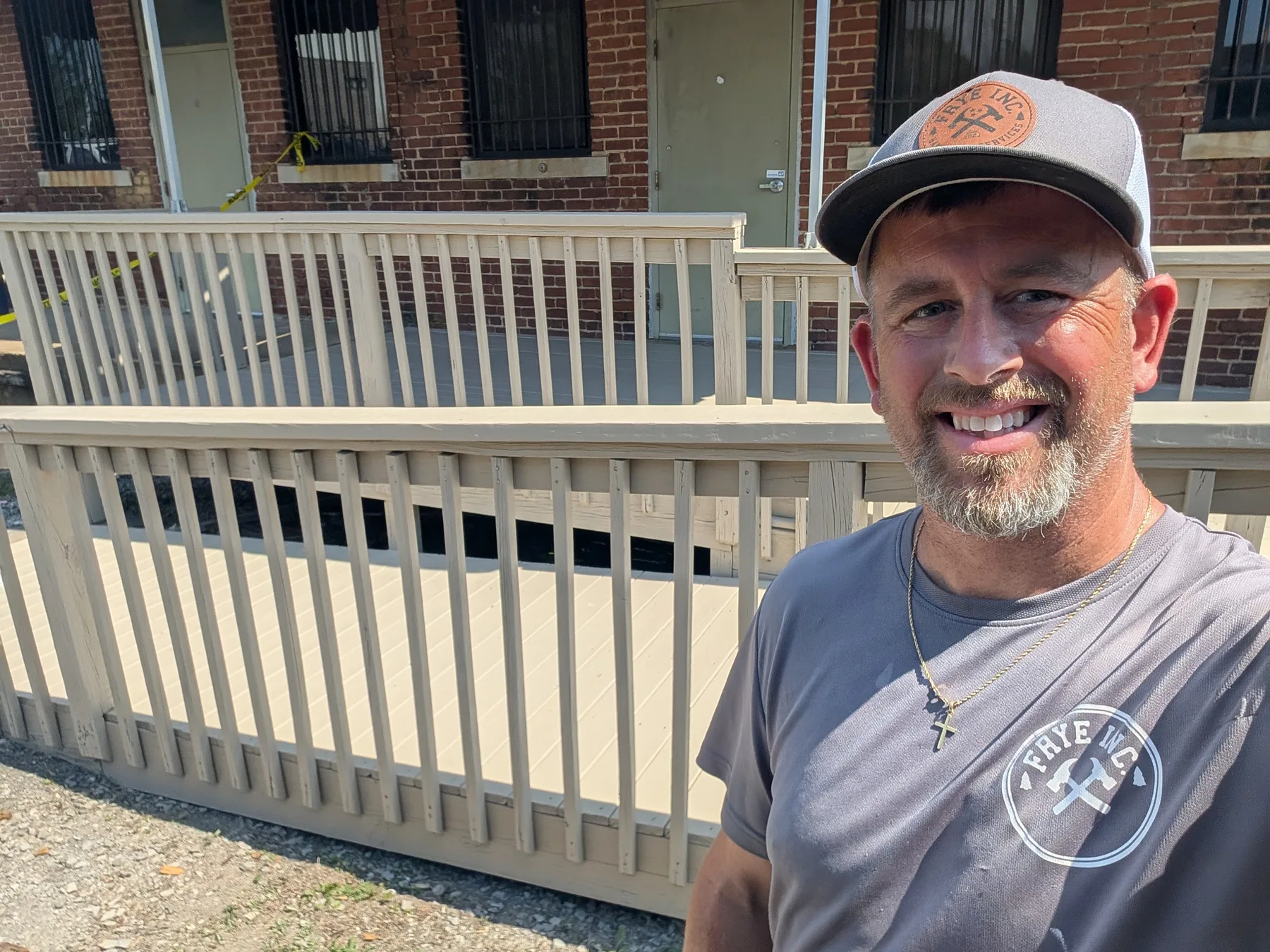 Colby Frye standing beside a completed accessibility ramp project