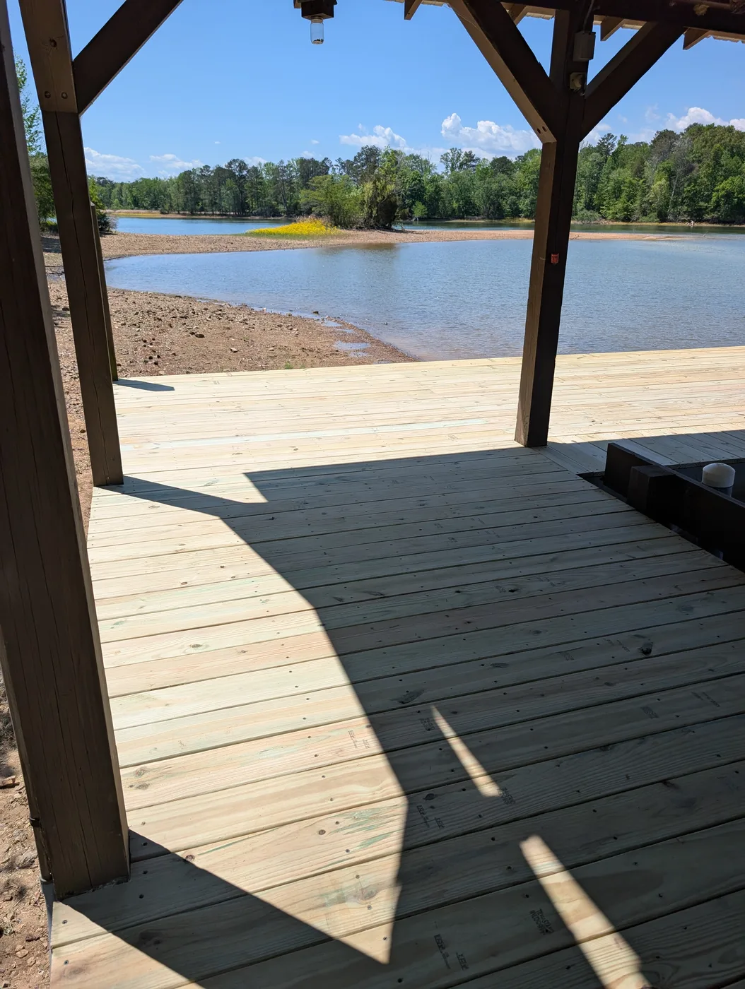 Replacement wood decking around a covered boat dock, completed by Frye Inc.