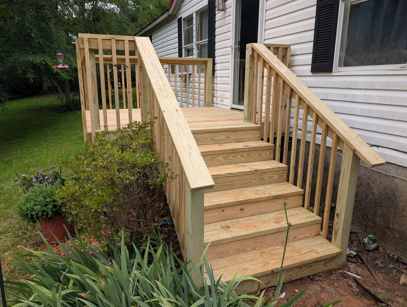Wooden entry steps and railings completed by Frye Inc.