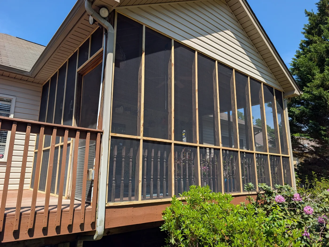 Screened porch with natural wood framing above a garden, from a Frye Inc. project