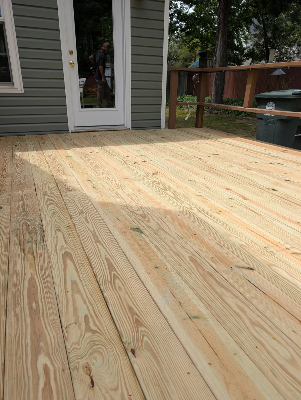 Natural wood deck boards outside a patio door, from a Frye Inc. project