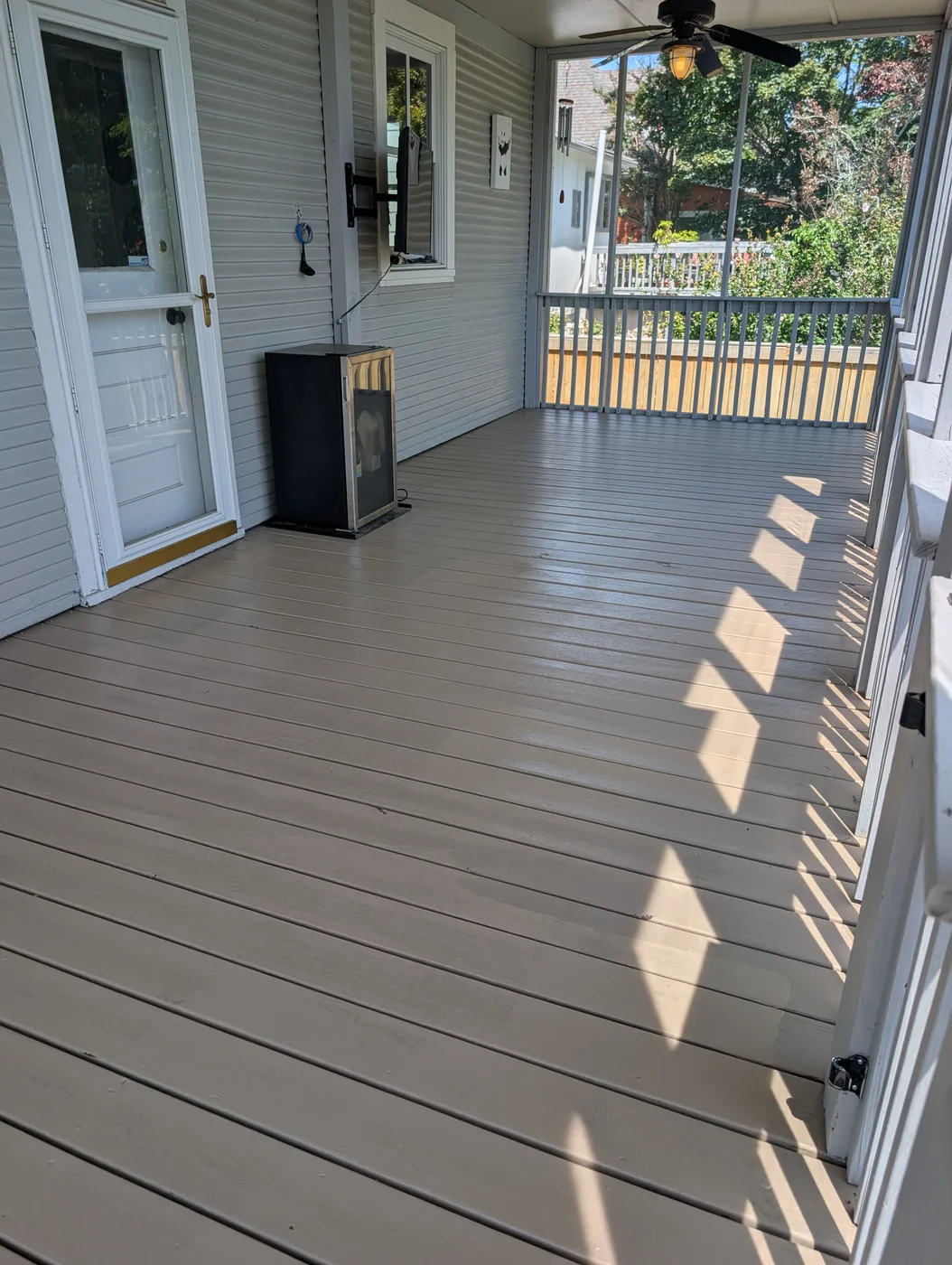Finished gray floor inside a screened porch, from a Frye Inc. project