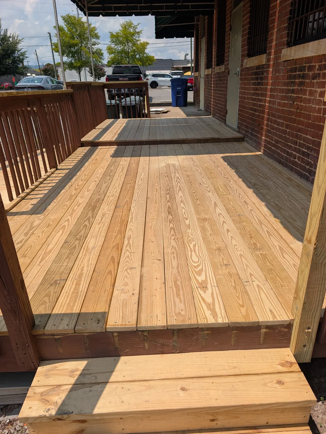 Wood deck with matching railings and steps completed by Frye Inc.