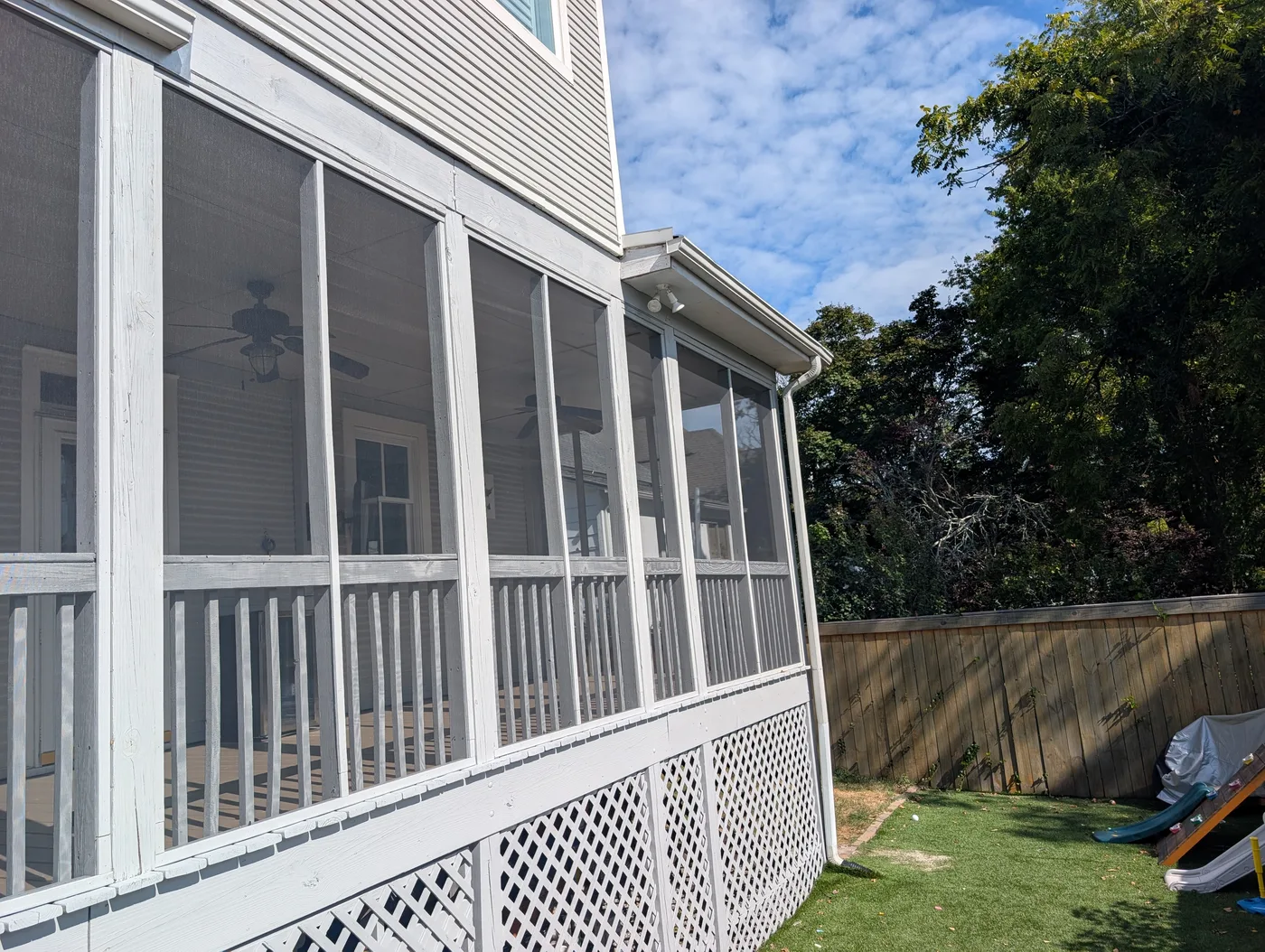 White screened porch with railing and lattice below, from a Frye Inc. project