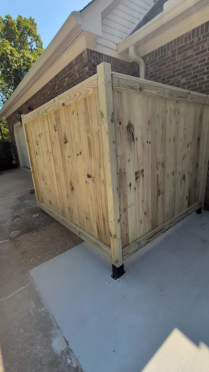 Wooden privacy panels beside a brick exterior, from a Frye Inc. project